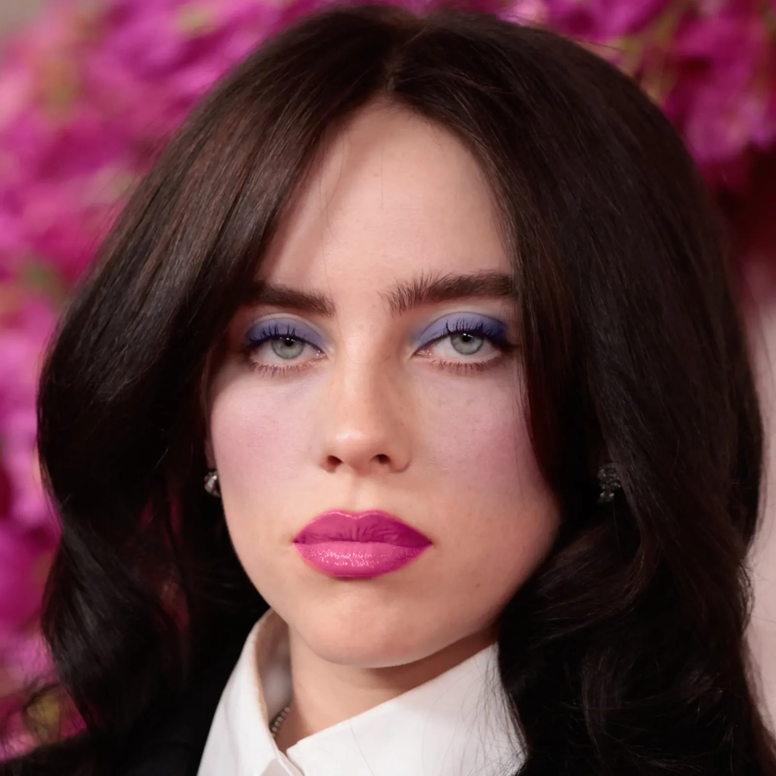 Billie Eilish with cool makeup — periwinkle shadow and vivid fuchsia lip