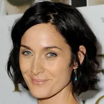 Carrie-Anne Moss — Bright Winter celebrity example, near-black hair, fair cool skin and striking grey-blue eyes