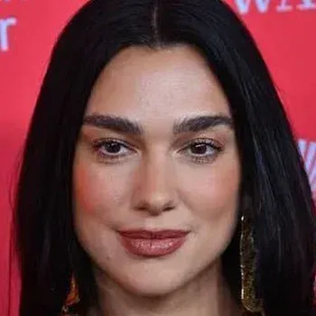 Dua Lipa — Deep Winter celebrity example, near-black hair, fair-medium cool-neutral skin and dark grey-green eyes