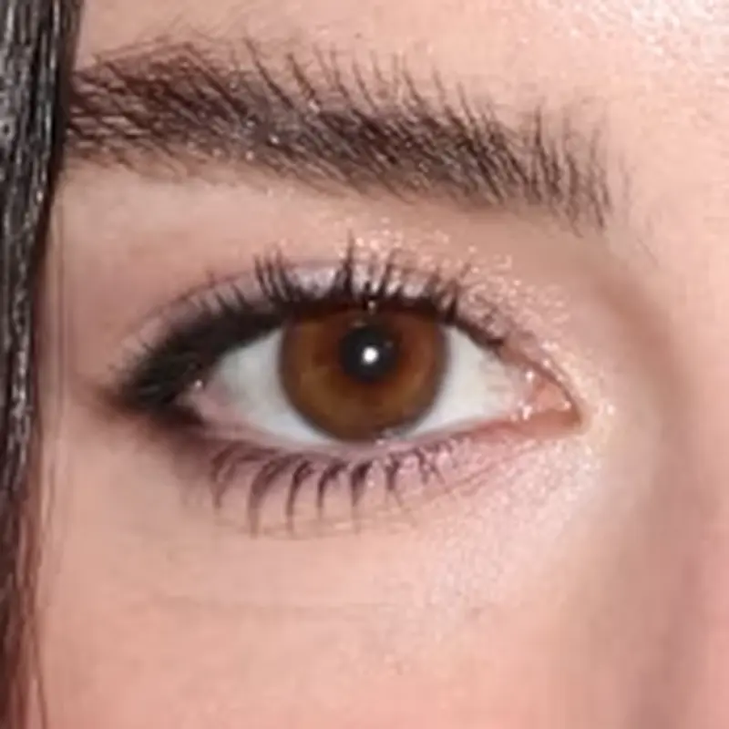Gracie Abrams' eyes — warm amber-brown with golden clarity