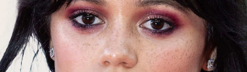 Jenna Ortega's eyes — very dark warm brown, high depth