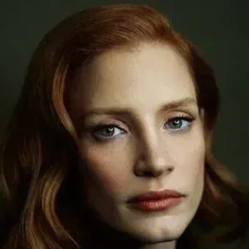 Jessica Chastain portrait — warm copper-auburn hair, fair peachy skin, blue-green eyes, True Spring celebrity colour analysis example