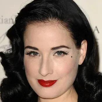 Dita Von Teese — True Winter celebrity example, near-black hair, porcelain very fair cool skin and cool grey-green eyes
