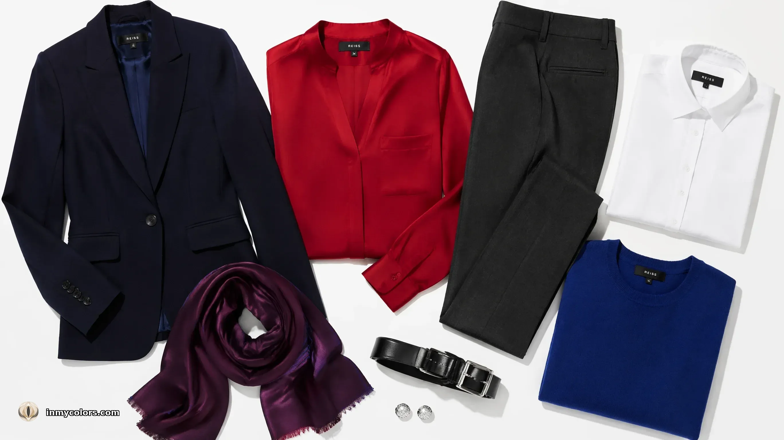 True Winter wardrobe capsule flatlay — midnight navy blazer, crisp white shirt, cool black trousers, cobalt accessory, silver jewellery, cool red lip colour reference